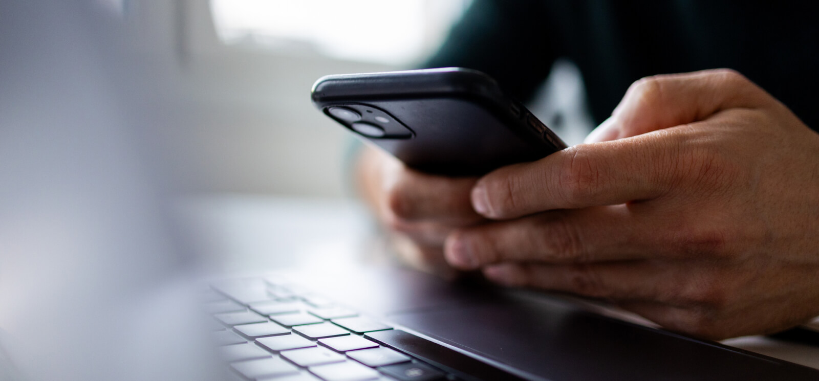 close-up of hands holding a smartphone