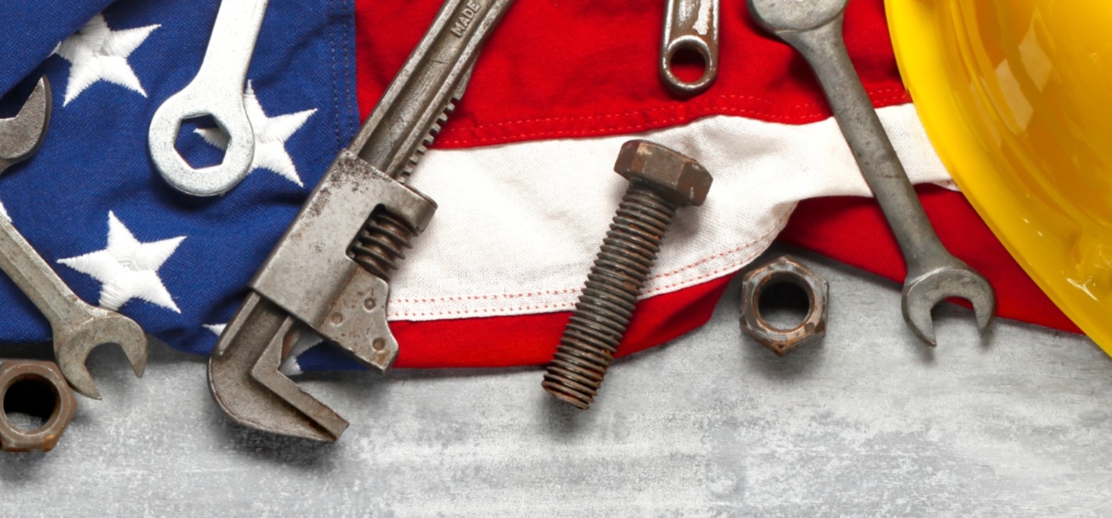 American flag with tools and hardhat